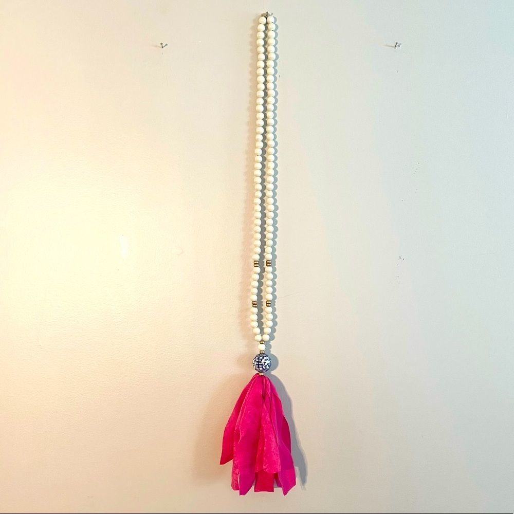 Long white bead with hot pink tassel necklace with blue and white accent
